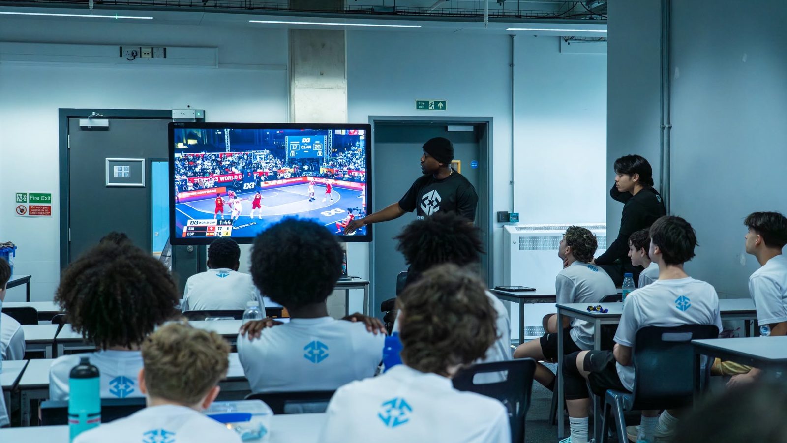 Afiz breaking down FIBA 3x3 World Cup film with campers in the classroom
